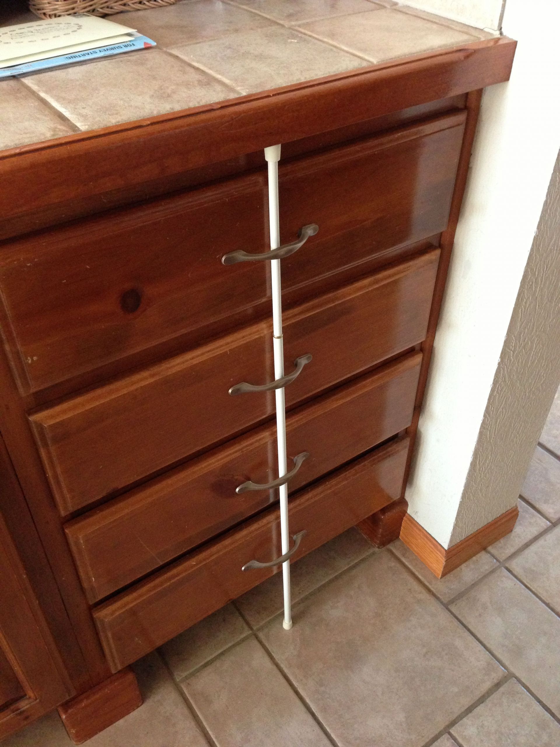 Baby Proof Cabinets DIY
 Childproof drawers use a tension rod to keep little ones