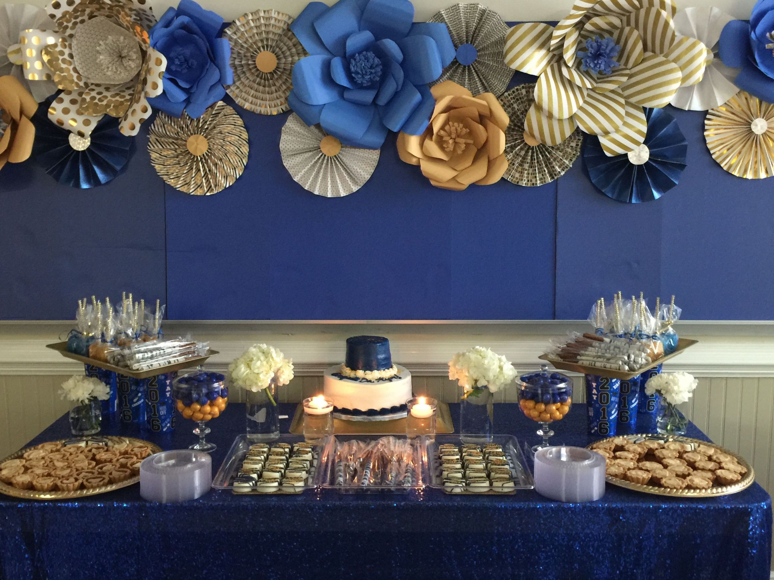 Blue And Gold Graduation Party Ideas
 Royal blue and gold dessert table with paper flowers and