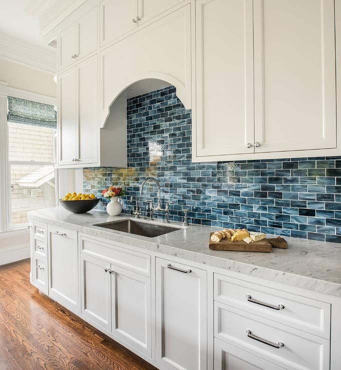 Blue Kitchen Tiles
 White and blue kitchen features white shaker cabinets