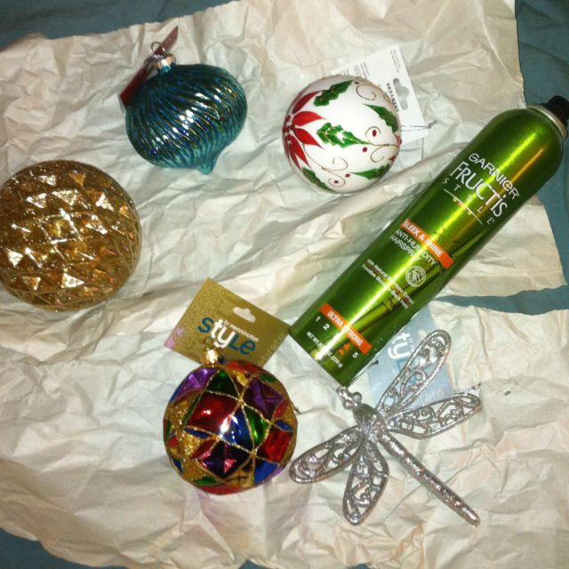 DIY Glitter Ornaments With Hairspray
 Spray glittery new ornaments with hairspray to keep the