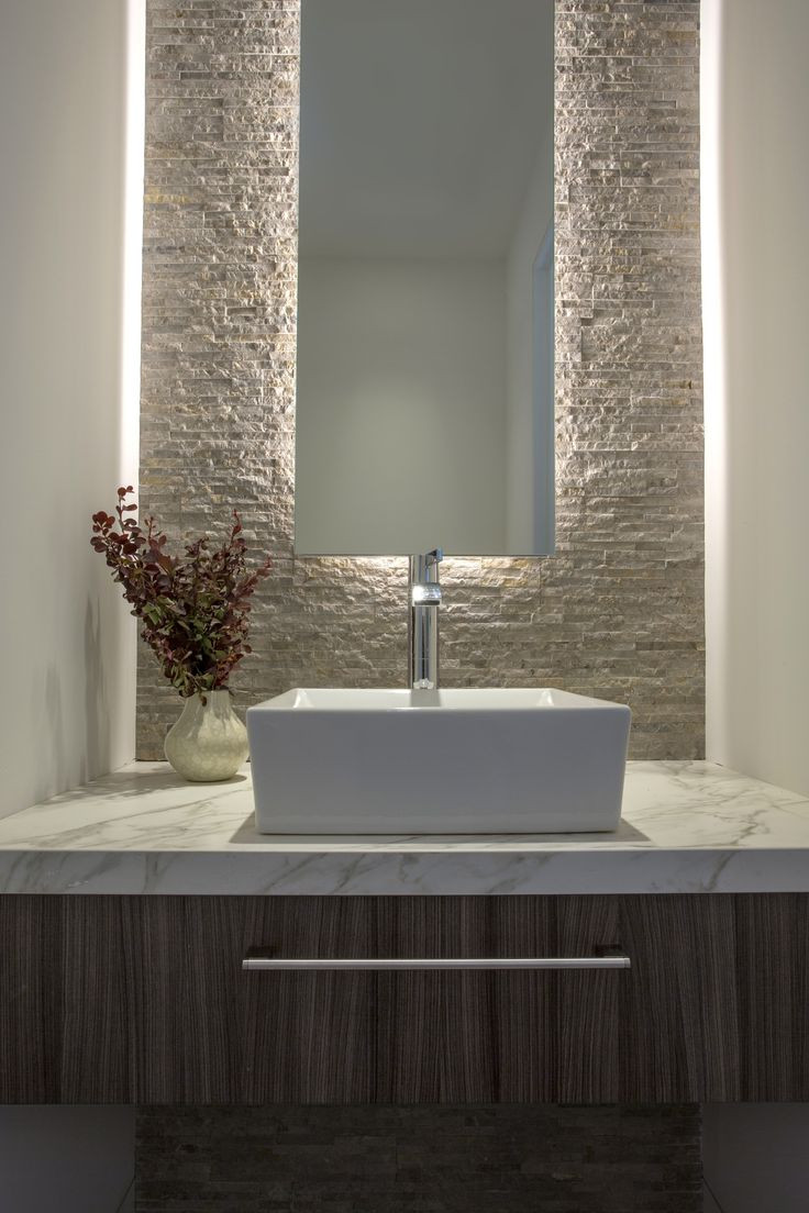 Floating Bathroom Mirror
 Back lit mirror against textured stone wall vessel sink