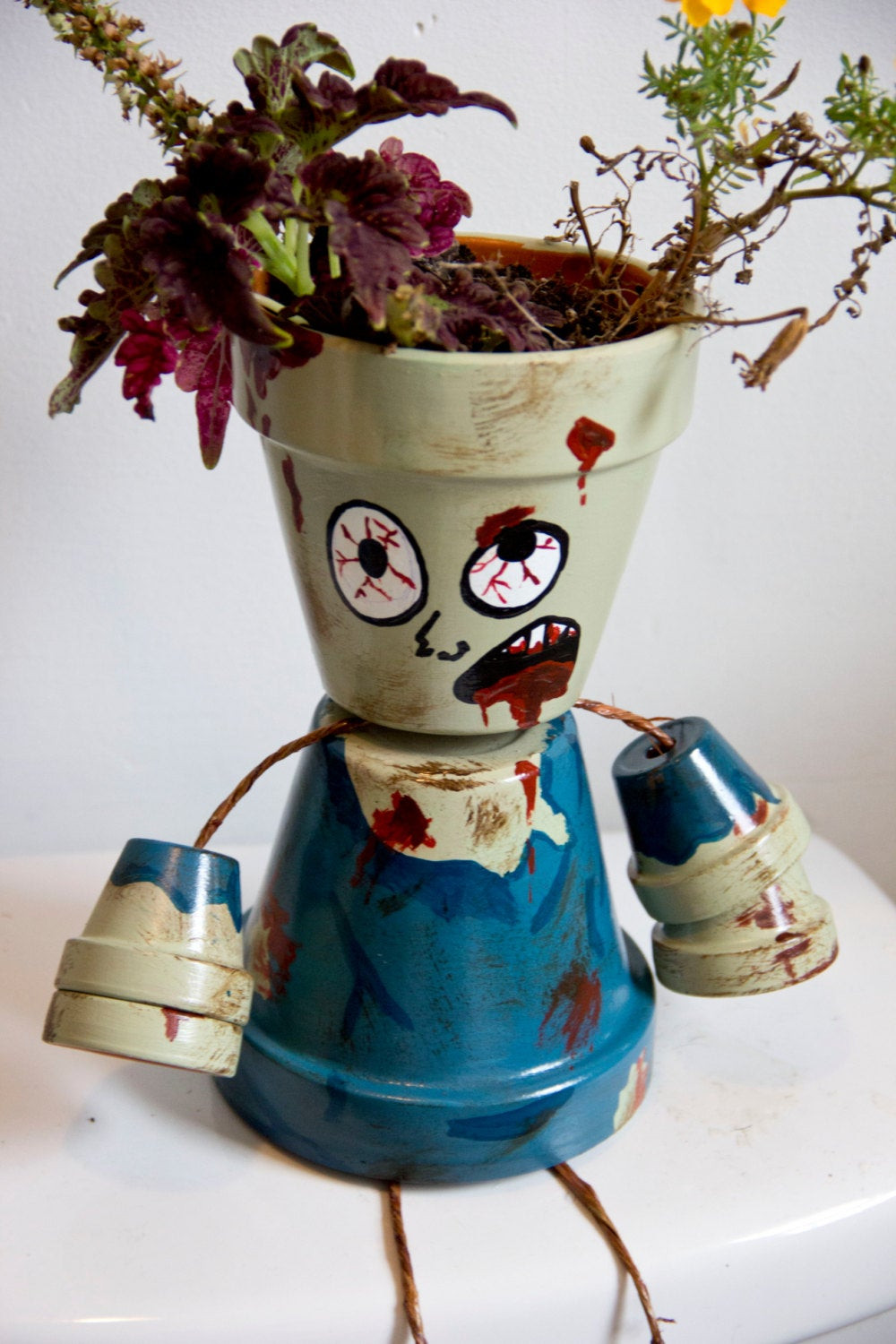 Halloween Flower Pots
 Halloween themed Zombie flower pot person by SchumArt on Etsy