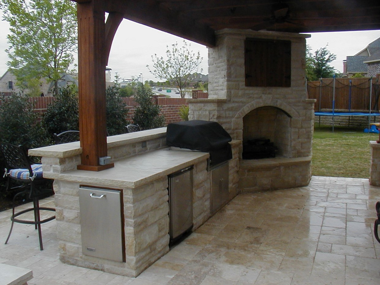 Outdoor Kitchen And Fireplace
 Interior Corner Kitchen with Corner Range and Fireplace