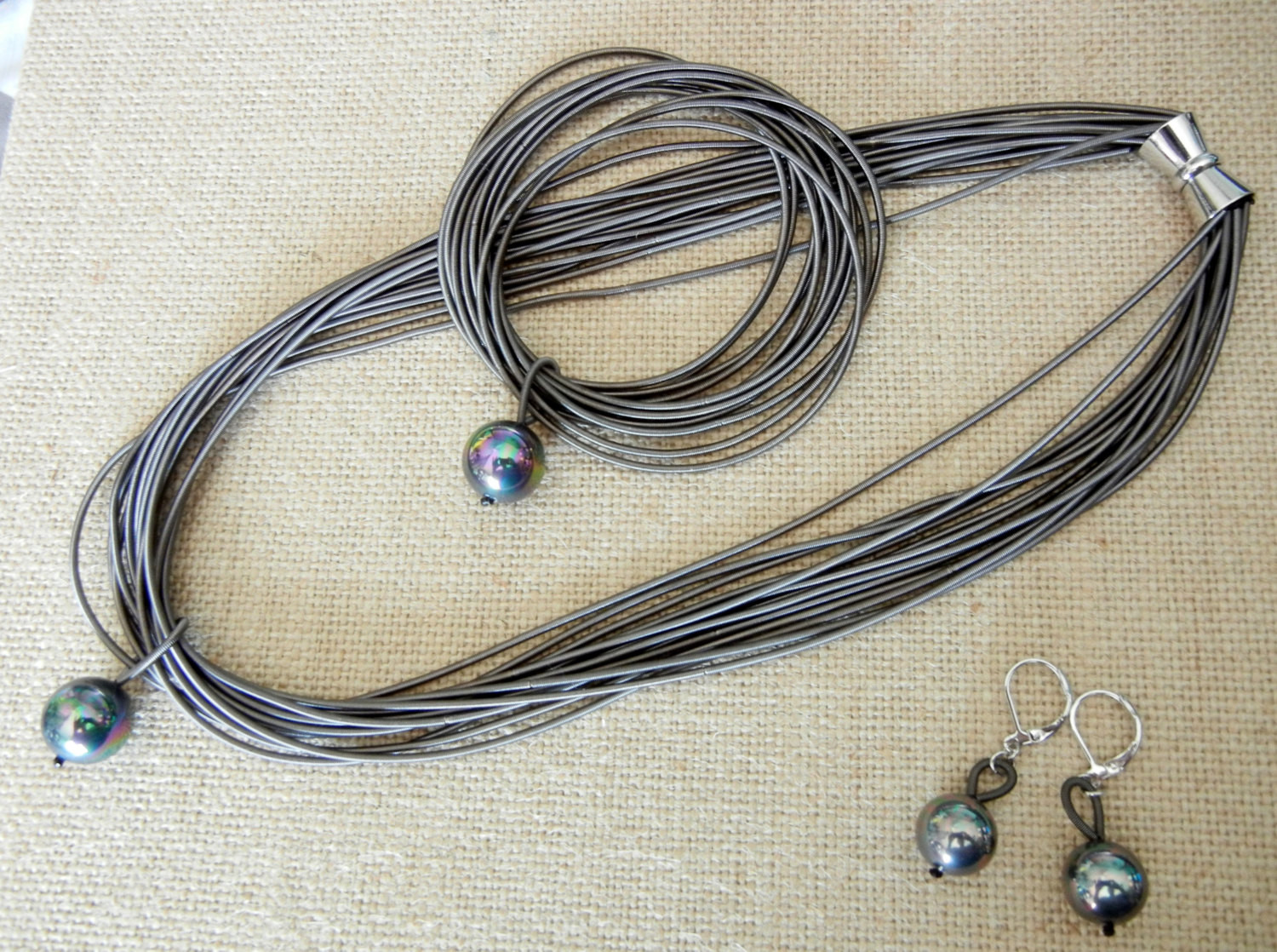 Piano Wire Necklace
 Piano Wire Necklace Slate with black pearl set by Cre8tvqn