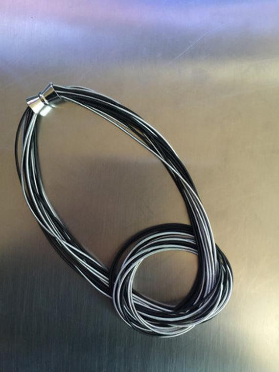 Piano Wire Necklace
 Piano Wire Necklace with Black & Silver color knot