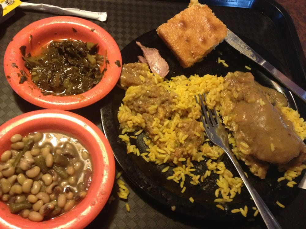 Smothered Pork Chops And Rice
 Smothered pork chops with yellow rice collards and field