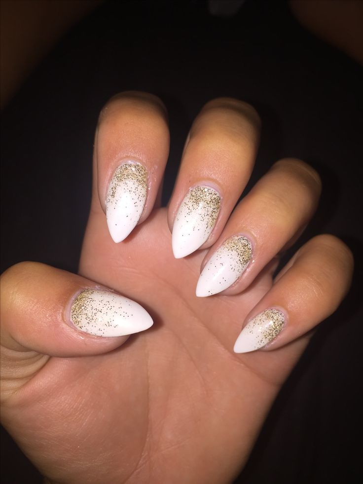 White Nails With Gold Glitter
 White stiletto nails with gold ombré accent