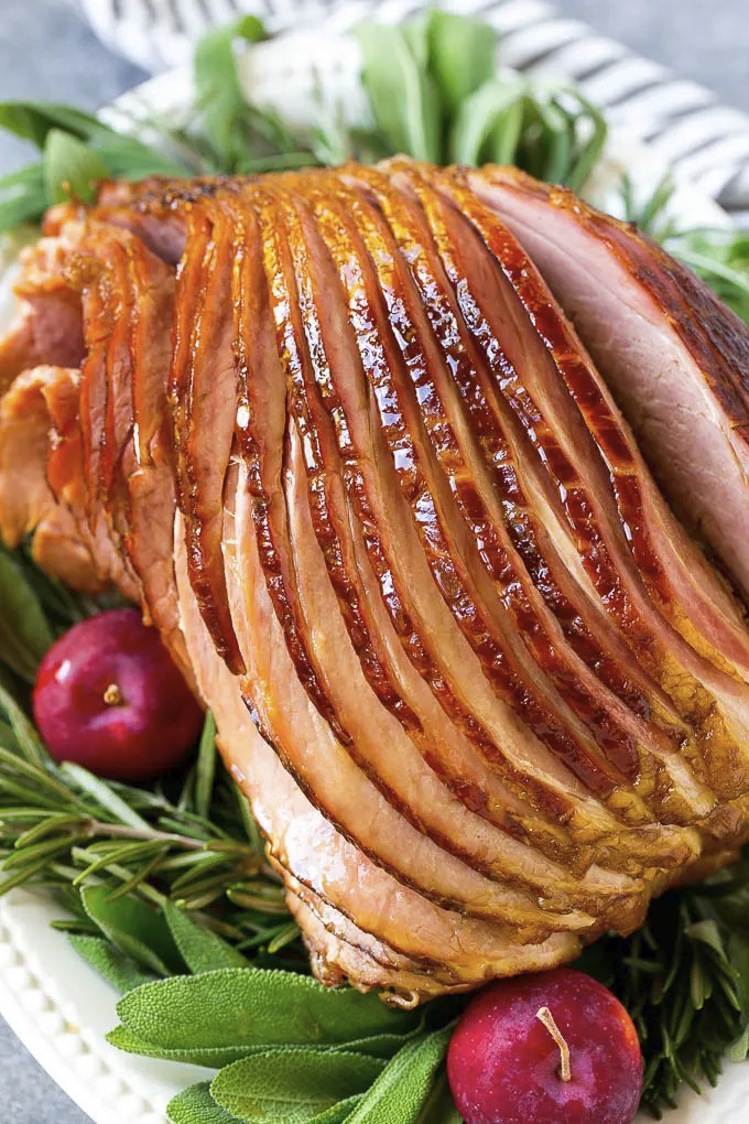 Easter Ham Crock Pot Recipes
 A crock pot ham on a serving plate with herbs and apples